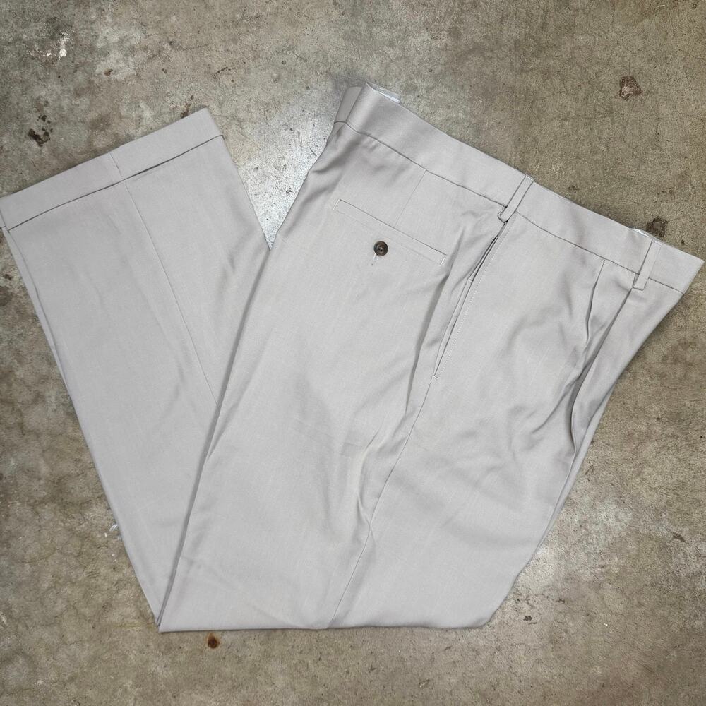 Haggar classic fit men’s dress pant size 44x32 tan, pleated front, cuffed leg.